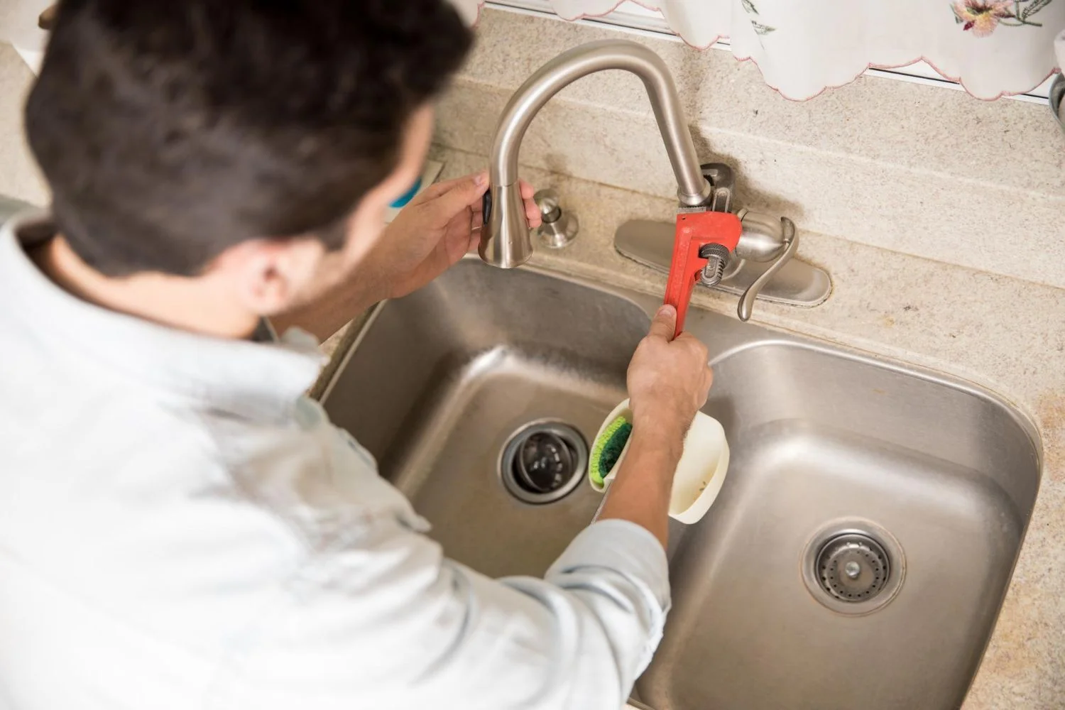 male-plumber-using-wrench-tighten-water-faucet-kitchen-seen-up-close-2880w